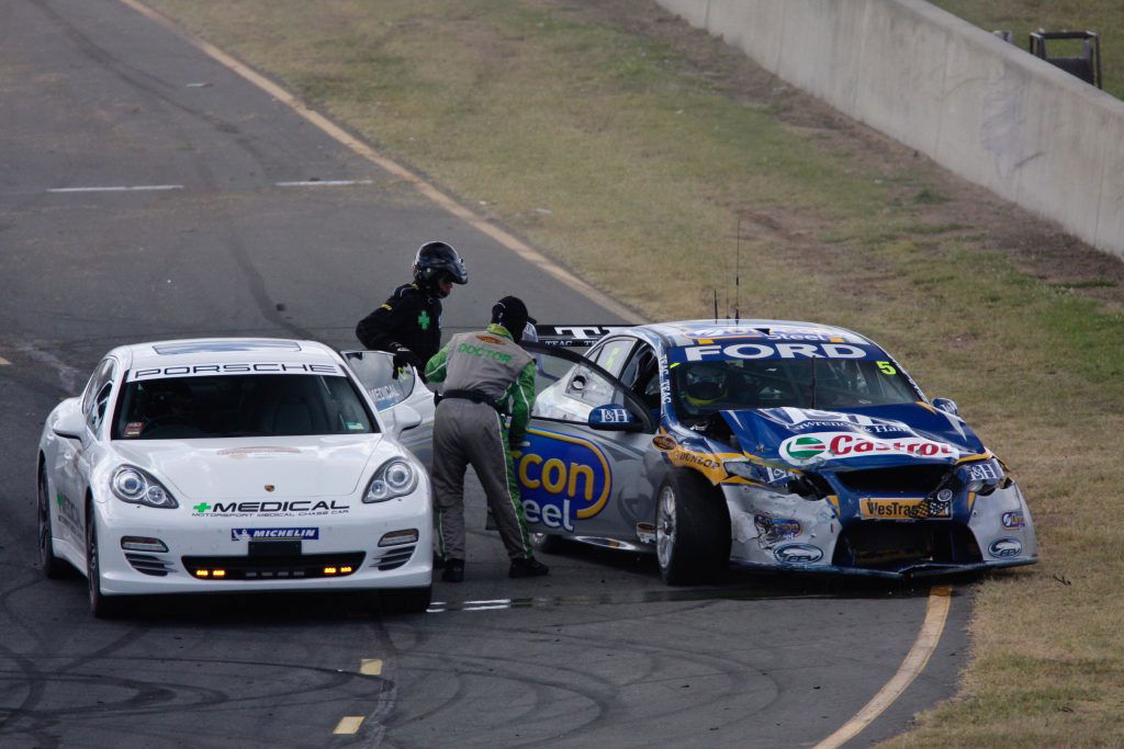 Dr Carl Le responding to a crash for Mark Winterbottom at Queensland Raceway in 2010. Image: Supplied