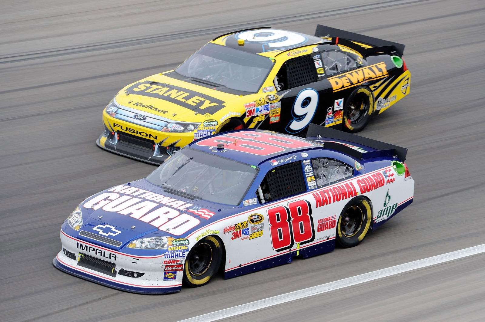 Dale Earnhardt Jr, driver of the #88 National Guard/Amp Energy Chevrolet, races Marcos Ambrose, driver of the #9 Stanley Ford, during the NASCAR Sprint Cup Series Kobalt Tools 400 at Las Vegas Motor Speedway in 2011. 