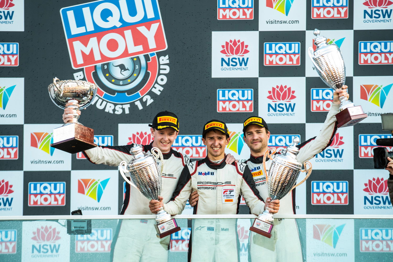 Matt Campbell celebrates with co-drivers Dennis Olsen and Dirk Werner