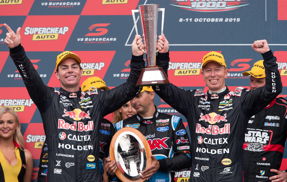 Craig Lowndes and Steve Richards hold the Peter Brock perpetual trophy aloft after their win last year