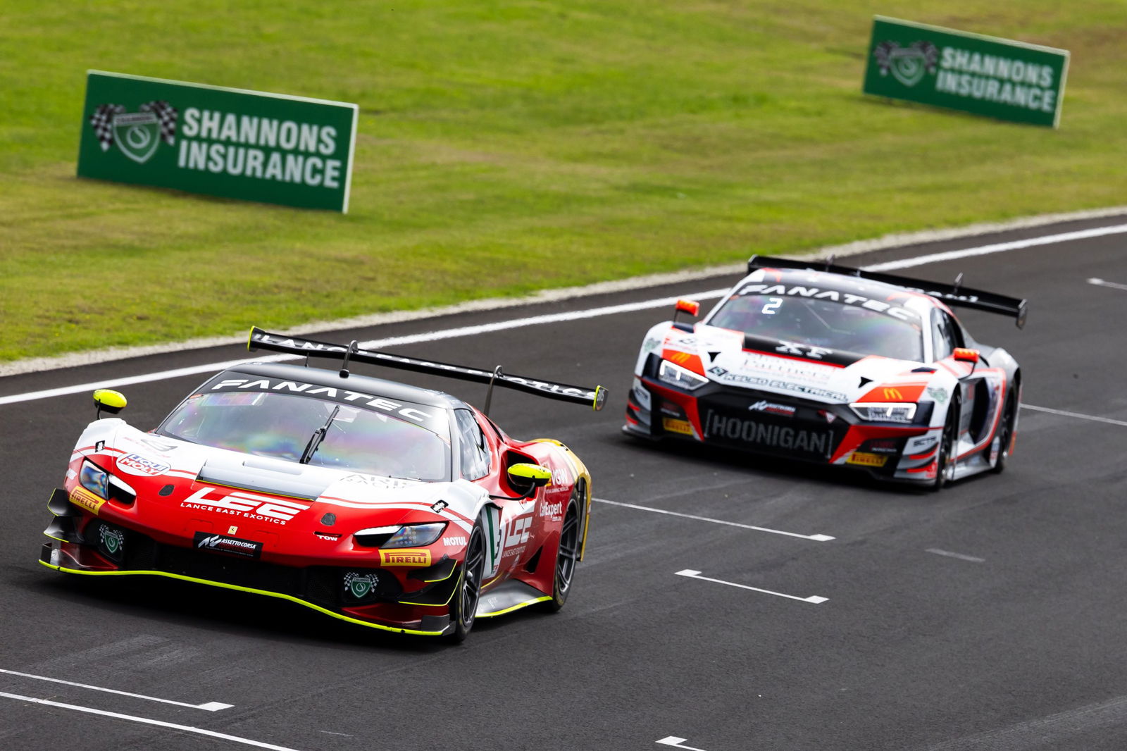 A Ferrari 296 GT3 leads an Audi R8 GT3 at Phillip Island.