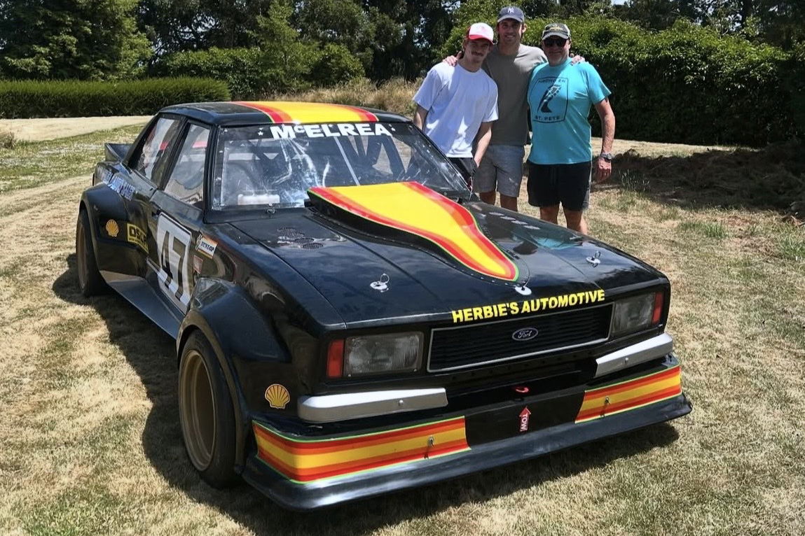Andy McElrea (right) with his sons Hunter (middle) and Cooper with Rod McElrea's OSCA-winning Chev Cortina.