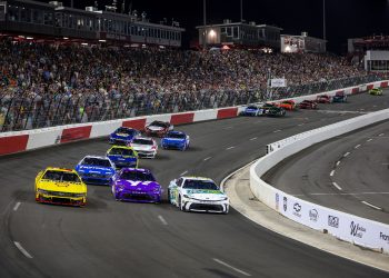 Joey Logano, driver of the #22 Shell Pennzoil Ford, Christopher Bell, driver of the #20 Yahoo! Toyota, and Denny Hamlin, driver of the #11 Mavis Tire Toyota, race during the NASCAR Cup Series All-Star Race at North Wilkesboro Speedway on May 19, 2024 in North Wilkesboro, North Carolina.