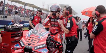 Ducati engineer Marco Rigamonti speaks with Marc Marquez before the United States Motorcycle Grand Prix.
