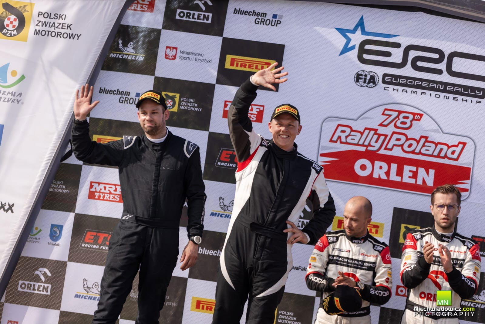 Tom Kristensson and Andreas Johansson celebrate on the European Rally Championship podium.