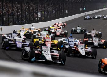 Cars fan out on a restart during the 2025 Indianapolis 500.