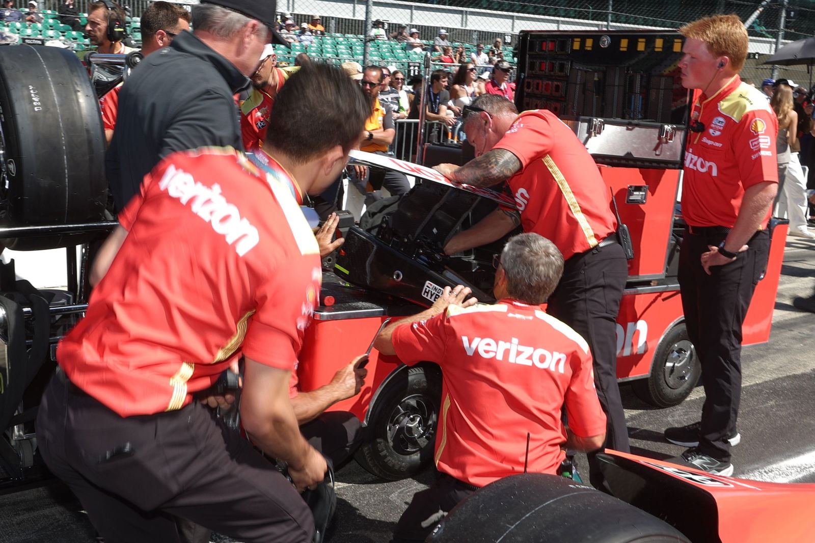 The members of the Penske -Crew team work on the back of one of his cars.