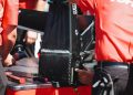 Team Penske crew members work on the rear attenuator of one of its cars.