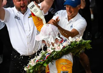 Josef Newgarden douses himself in milk after winning the 2023 Indianapolis 500.