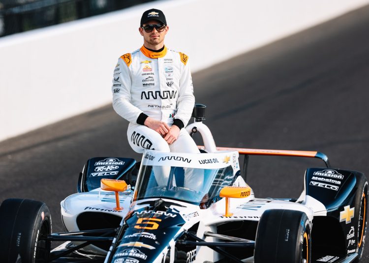 Pato O'Ward sits atop his Indy car as part of the front row shoot. Image: Joe Skibinski