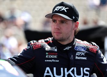 Cam Waters, driver of the #60 AUKUS/BuildSubmarines.com Ford, looks on during qualifying for the NASCAR Cup Series Toyota/Save Mart 350 at Sonoma Raceway in 2024.