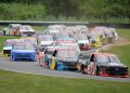 The NASCAR Craftsman Truck Series field heads through the second turn at Lime Rock Park.