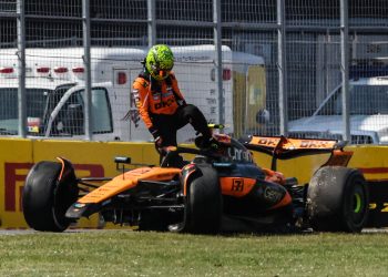 Lando Norris gets out of his McLaren after crashing with Oscar Piastri.