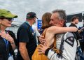 Tim Miles hugs his daughter after finishing on the podium in the Mustang Challenge Le Mans Invitational.