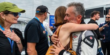 Tim Miles hugs his daughter after finishing on the podium in the Mustang Challenge Le Mans Invitational.