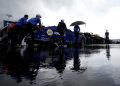 Crew members push the #9 NAPA Auto Parts Chevrolet, driven by Chase Elliott in the garage area during a weather delay of practice for the NASCAR Cup Series AutoTrader EchoPark Automotive 400 at Dover Motor Speedway.