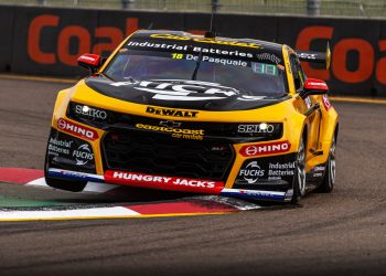 The #18 Team 18 DeWalt Chevrolet Camaro driven by Anton De Pasquale over a kerb at Townsville.