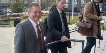 Front Row Motorsports owner Bob Jenkins, left, and 23XI co-owner Denny Hamlin arrive in the Western District of North Carolina on Monday Dec 1, 2025 in Charlotte, N.C. (AP Photo/Jenna Fryer, File)