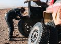 Toby Price works on his damaged Overdrive Racing Toyota HiLux.