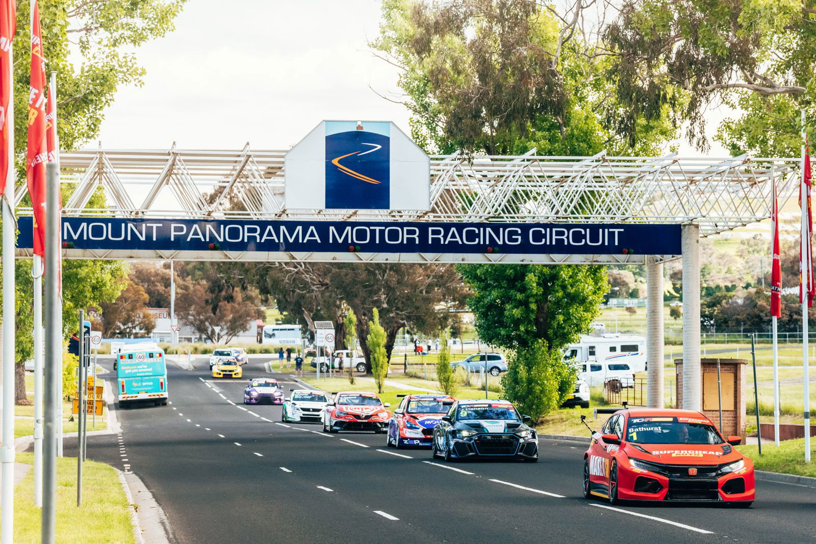 TCR cars drive from Mount Panorama to downtown Bathurst.