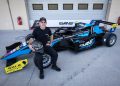 Aaron Cameron poses with the car he'll race in the Formula Regional Middle East Championship with Evans GP.