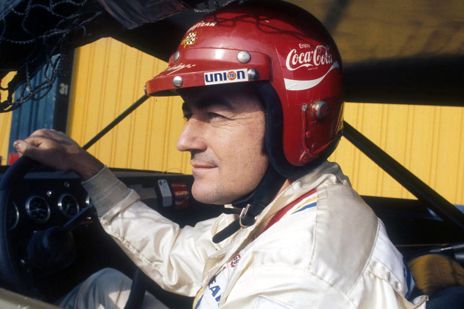 Bobby Allison gets set to race wearing his Coca-Cola helmet before the Winston Western 500 race on January 23, 1972 at the Riverside International Raceway. 