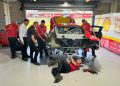 Supercars tech staff observe as DJR strips the damaged Mustang.