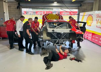 Supercars tech staff observe as DJR strips its damaged Mustang.