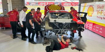 Supercars tech staff observe as DJR strips its damaged Mustang.