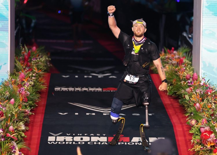 Billy Monger celebrates completing the Ironman World Championship in Hawaii.