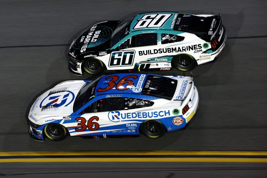 DAYTONA BEACH, FLORIDA - FEBRUARY 15: Kaz Grala, driver of the #36 Ruedebusch Ford, and David Ragan, driver of the #60 BuildSubmarines.com Ford, race during the NASCAR Cup Series Bluegreen Vacations Duel #2 at Daytona International Speedway on February 15, 2024 in Daytona Beach, Florida. (Photo by Sean Gardner/Getty Images)