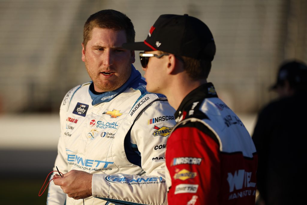 HAMPTON, GEORGIA - FEBRUARY 23: Austin Hill, driver of the #21 Bennett Transportation Chevrolet, (L) and Jesse Love, driver of the #2 Whelen Chevrolet, talk on the grid during qualifying for the NASCAR Xfinity Series King of Tough 250 at Atlanta Motor Speedway on February 23, 2024 in Hampton, Georgia. (Photo by Alex Slitz/Getty Images)