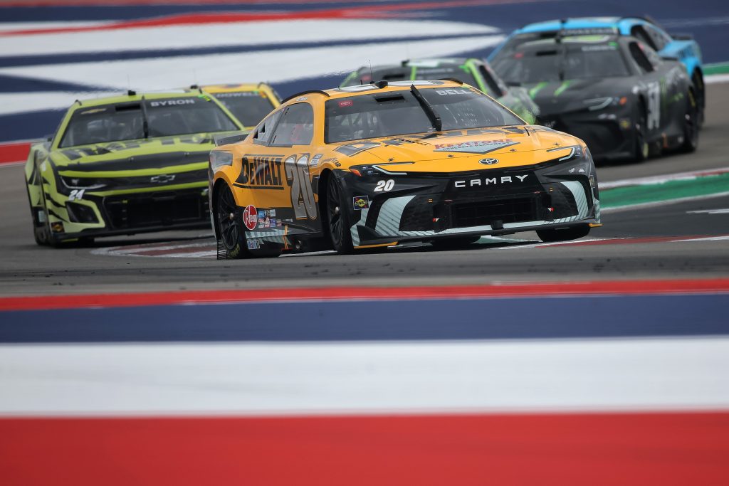 AUSTIN, TEXAS - MARCH 24: Christopher Bell, driver of the #20 DEWALT Toyota, and William Byron, driver of the #24 RaptorTough.com Chevrolet, race during the NASCAR Cup Series EchoPark Automotive Grand Prix at Circuit of The Americas on March 24, 2024 in Austin, Texas. (Photo by Jonathan Bachman/Getty Images)