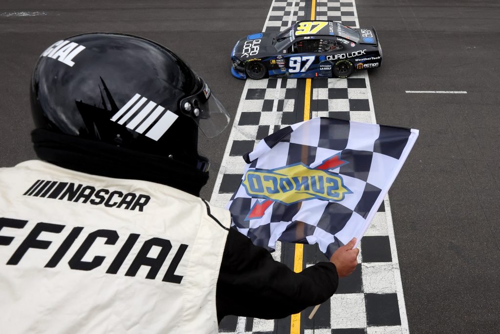 PORTLAND, OREGON - JUNE 01: Shane Van Gisbergen, driver of the #97 Quad Lock Chevrolet, takes the checkered flag to win the NASCAR Xfinity Series Pacific Office Automation 147 at Portland International Raceway on June 01, 2024 in Portland, Oregon. (Photo by Meg Oliphant/Getty Images)