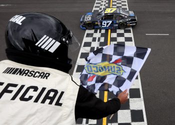 PORTLAND, OREGON - JUNE 01: Shane Van Gisbergen, driver of the #97 Quad Lock Chevrolet, takes the checkered flag to win the NASCAR Xfinity Series Pacific Office Automation 147 at Portland International Raceway on June 01, 2024 in Portland, Oregon. (Photo by Meg Oliphant/Getty Images)