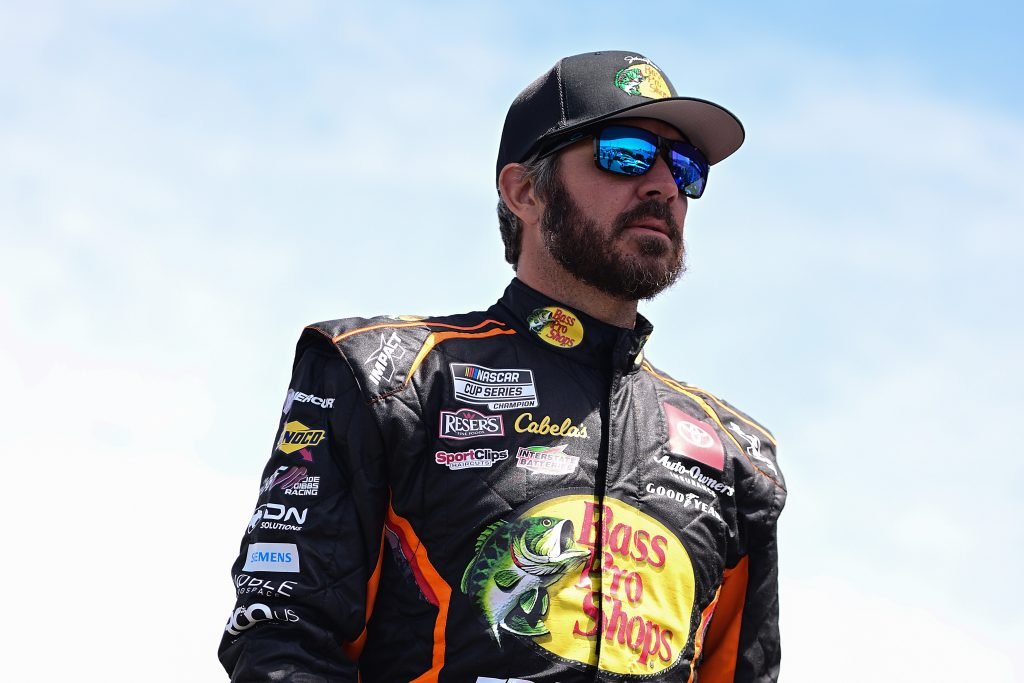 SONOMA, CALIFORNIA - JUNE 08: Martin Truex Jr., driver of the #19 Bass Pro Shops Toyota, walks the grid during qualifying for the NASCAR Cup Series Toyota/Save Mart 350 at Sonoma Raceway on June 08, 2024 in Sonoma, California. (Photo by Logan Riely/Getty Images)