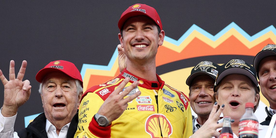 Joey Logano, driver of the #22 Shell Pennzoil Ford, and Team Penske owner, Roger Penske celebrate in victory lane after winning the NASCAR Cup Series Championship Race at Phoenix Raceway. Image: Jared C. Tilton/Getty Images