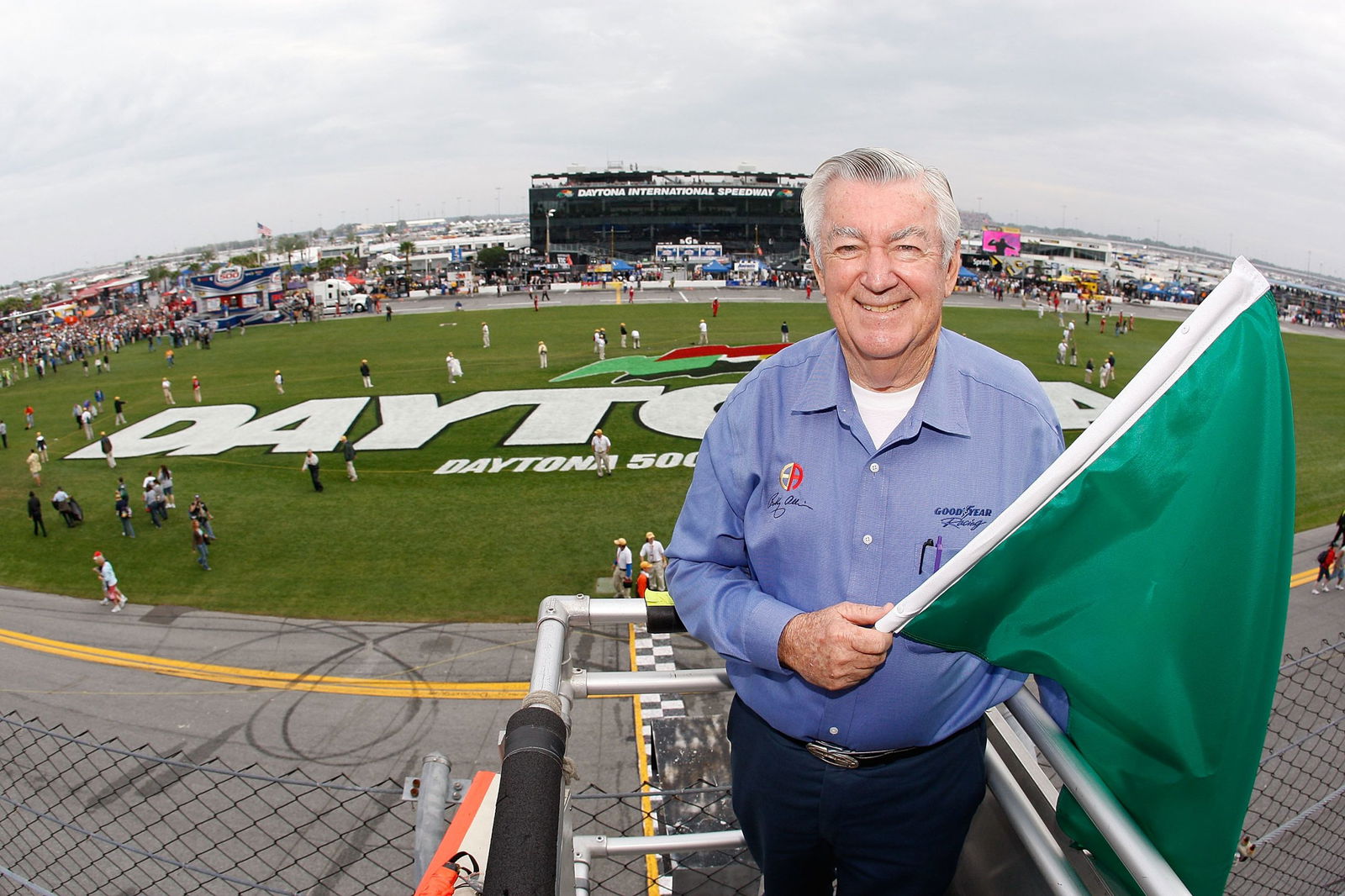 NASCAR legend Bobby Allison poses with the green flag prior to starting the NASCAR Cup Series Daytona 500 at Daytona International Speedway in 2009. Image: