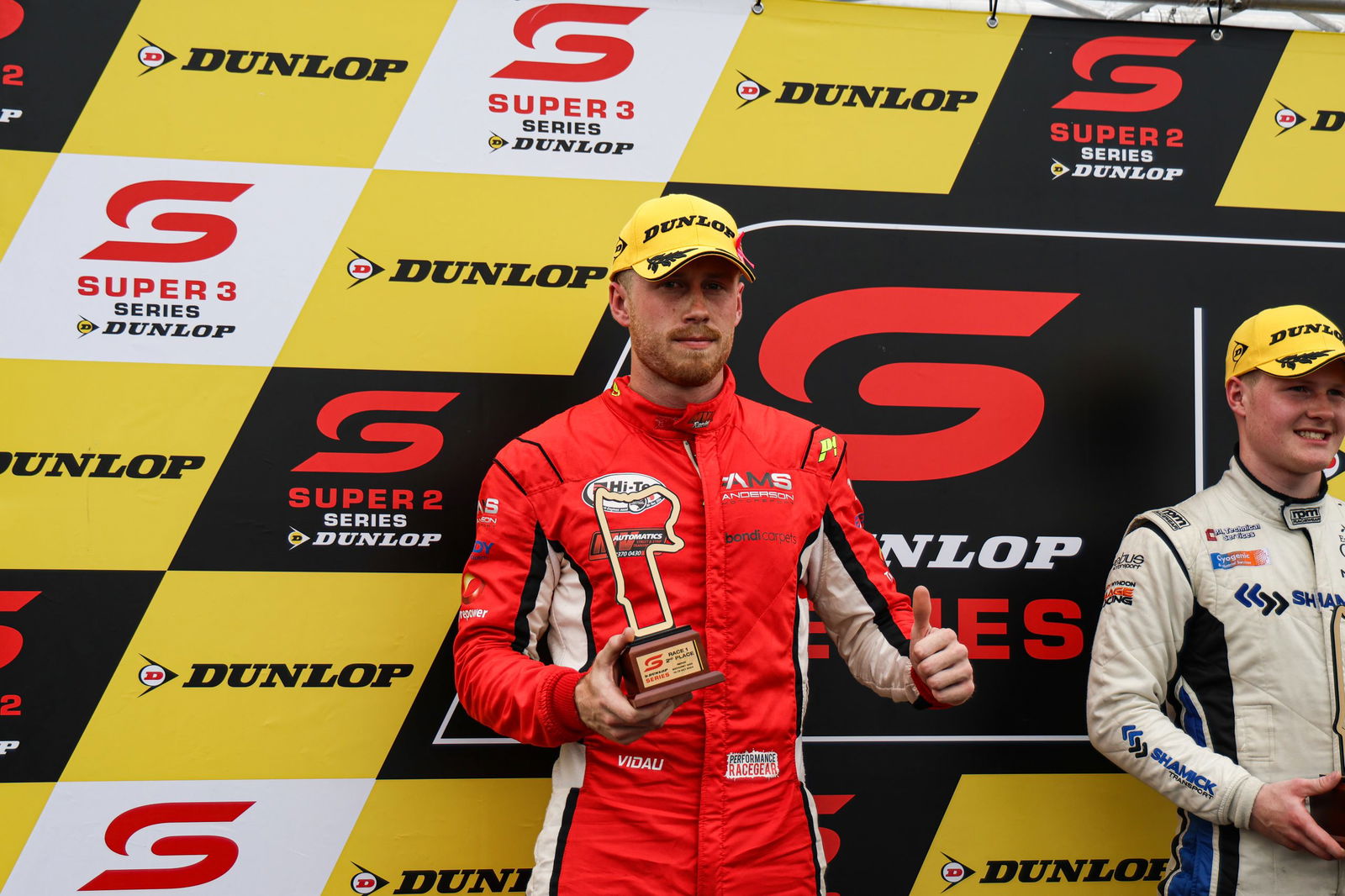 An ill Mix Vidau celebrates on the Super2 Series podium.