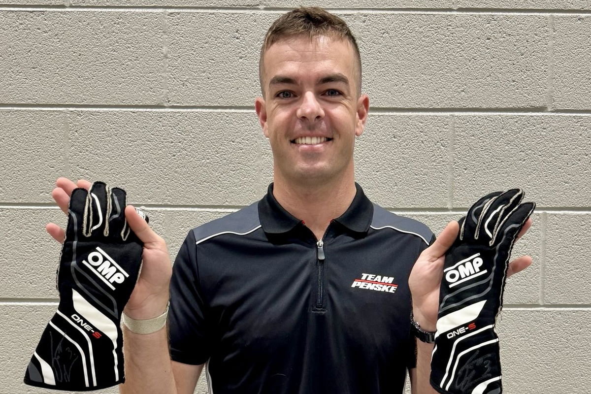 Scott McLaughlin with his race-winning gloves from Iowa Speedway.