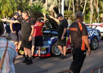 Triple Eight crew members look under the bonnet of Broc Feeney's Camaro; note also Supercars General Manager of Motorsport Tim Edwards in the foreground. Image: InSyde Media