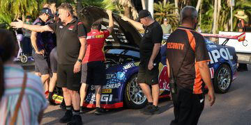 Triple Eight crew members look under the bonnet of Broc Feeney's Camaro; note also Supercars General Manager of Motorsport Tim Edwards in the foreground. Image: InSyde Media