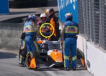 Alexander Rossi grasps his thumb after crashing at turn eight in Toronto.