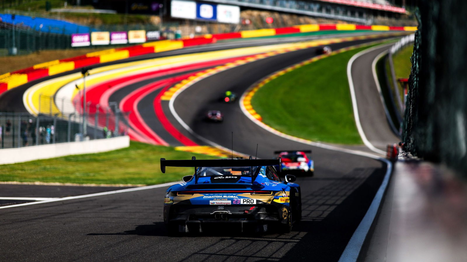 Jaxon Evans on approach to Eau Rouge in his Phantom Global Racing Porsche 911 GT3 R.