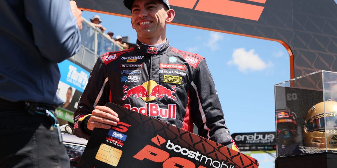 Broc Feeney wearing a Red Bull Ampol Racing hat while accepting the pole award in Bathurst. Image: Supercars