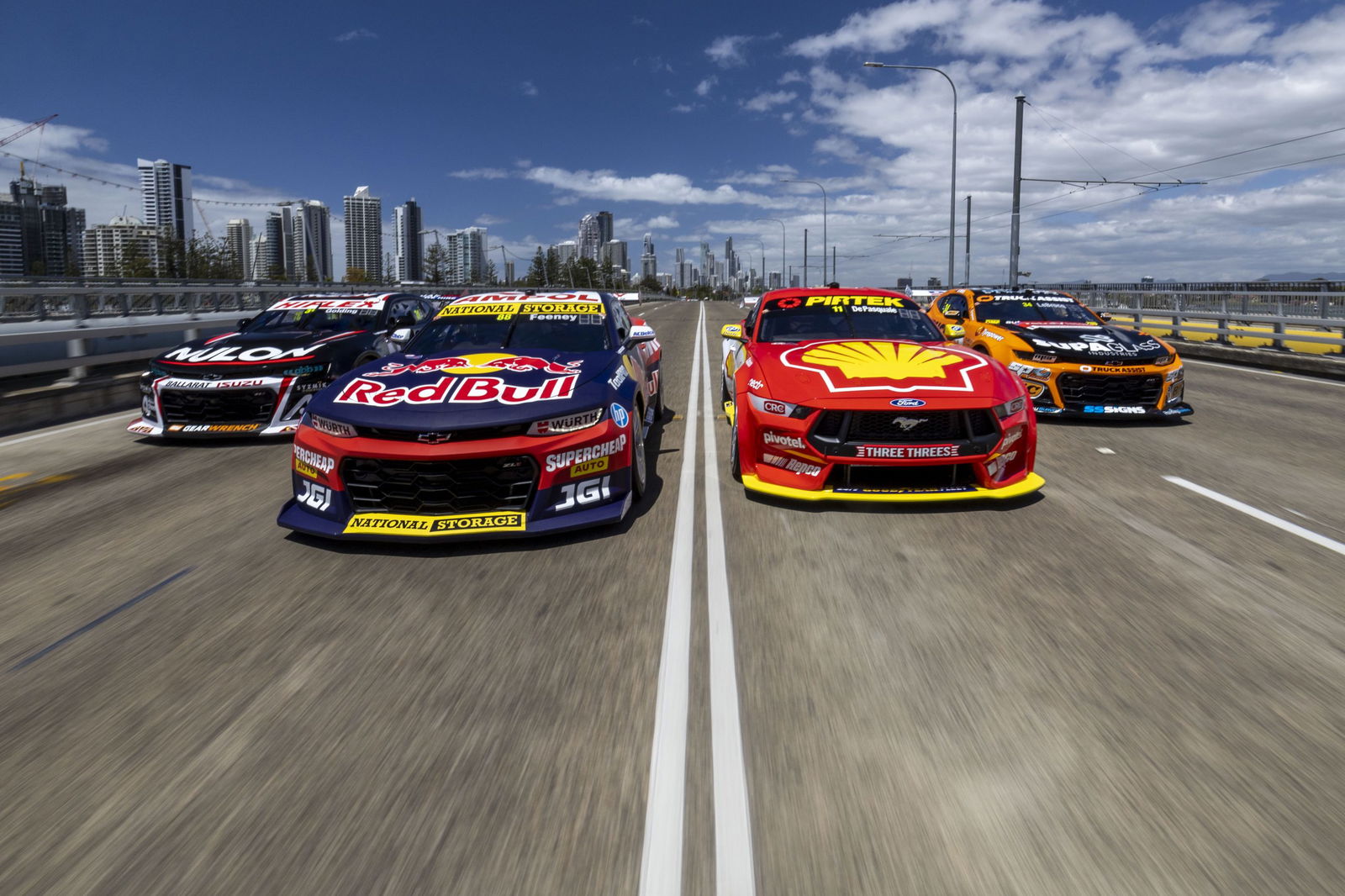 Supercars driving across the Gold Coast's Sundale Bridge in 2023.