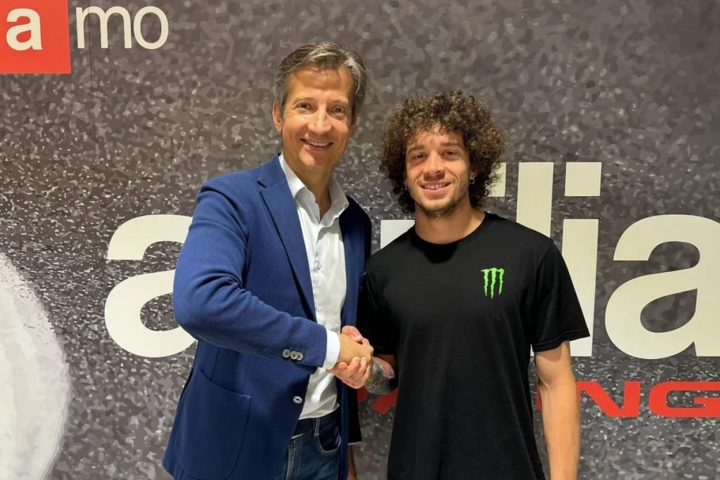 Aprilia Racing CEO Massimo Rivola (left) welcomes Marco Bezzecchi (right) to its MotoGP team. Image: Aprilia Racing