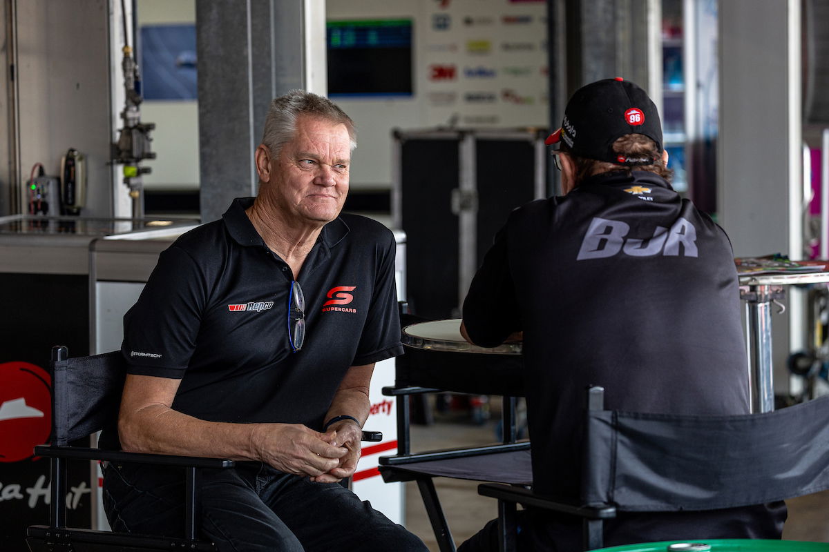 Campbell Little talks to Brad Jones at the back of a BJR garage at the Supercars Adelaide 500 in November 2023