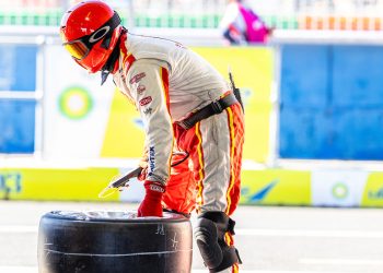 A Dick Johnson Racing crew member holding a tyre at the 2023 Bathurst 1000 at Mount Panorama