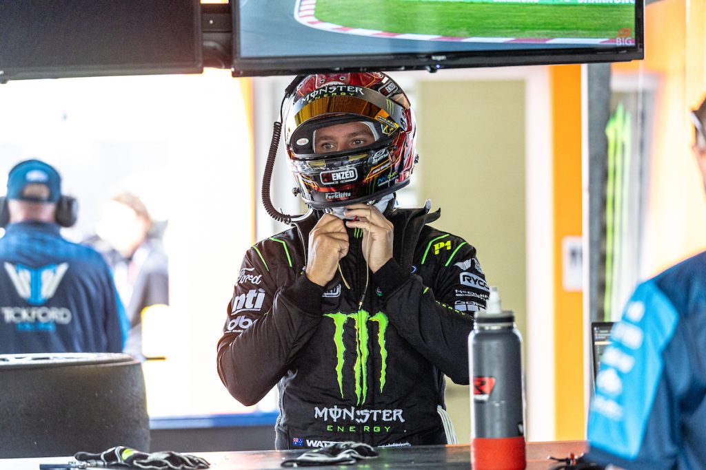 Cam Waters straps on his helmet in the Tickford Racing garage at Mount Panorama at the Supercars Bathurst 500 in February 2024. Image: InSyde Media